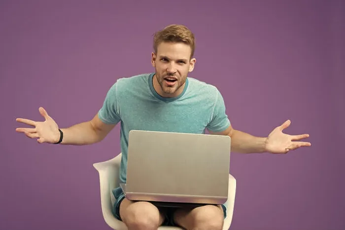 Framed Print : Angry man with laptop on violet background Framed Print : Angry man with laptop on violet background
