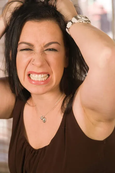 Framed Print : Angry young woman grits her teeth and pulls her hair out in frustration, USA Framed Print : Angry young woman grits her teeth and pulls her hair out in frustration, USA