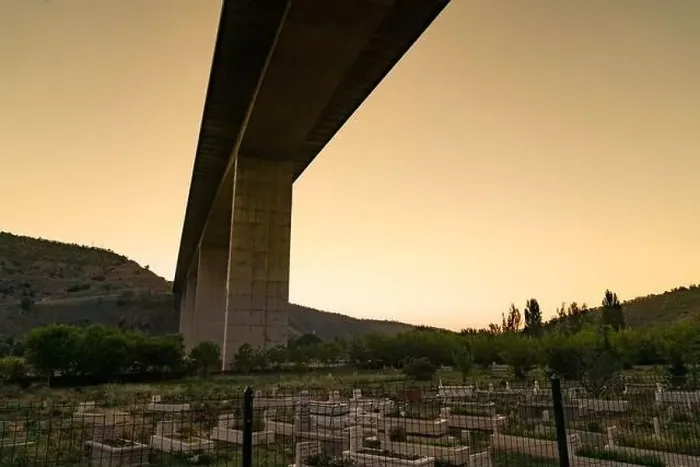 Framed Print : Ankara / Turkey-July 04 2020: Muslim cemetery under the highway viaduct