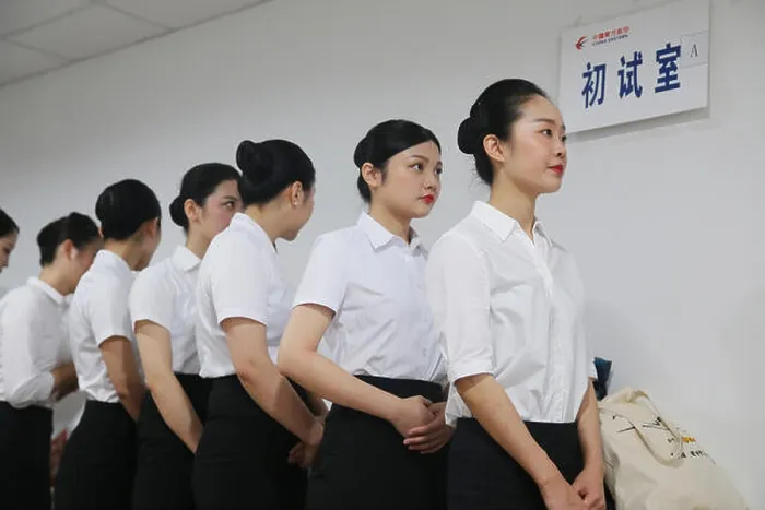 Framed Print : Applicants for China Eastern Airlines prepare to take part in an interview for flight attendant Framed Print : Applicants for China Eastern Airlines prepare to take part in an interview for flight attendant