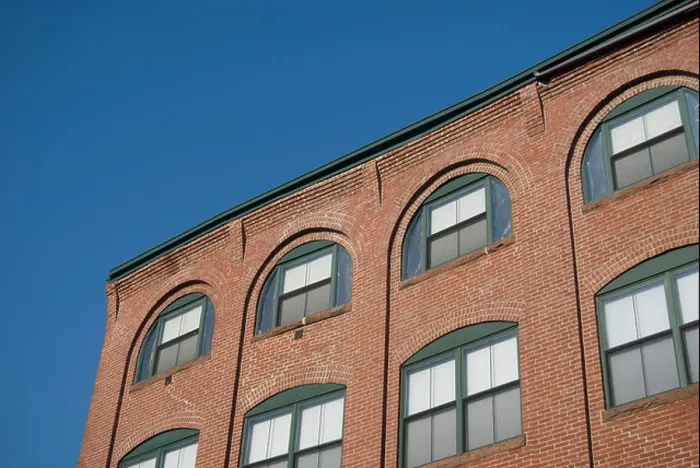 Framed Print : Arched windows in a brick warehouse wall, against a blue sky Framed Print : Arched windows in a brick warehouse wall, against a blue sky