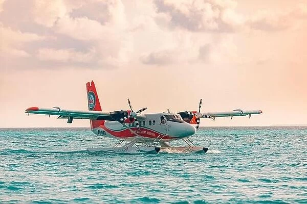 Ari Atoll, Maldives - 05.05.19: Seaplane at tropical beach resort. Luxury summer travel destination with seaplane in Maldives islands. Exotic vacation