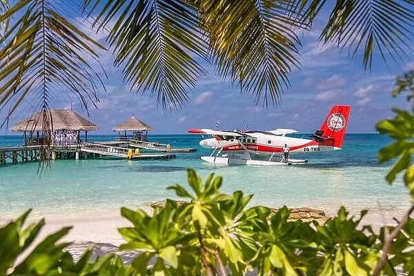 Ari Atoll, Maldives - 05.05.2018: Maldives seaplane on luxury resort, wooden jetty loading the plane, ready for departure. Tropical island background