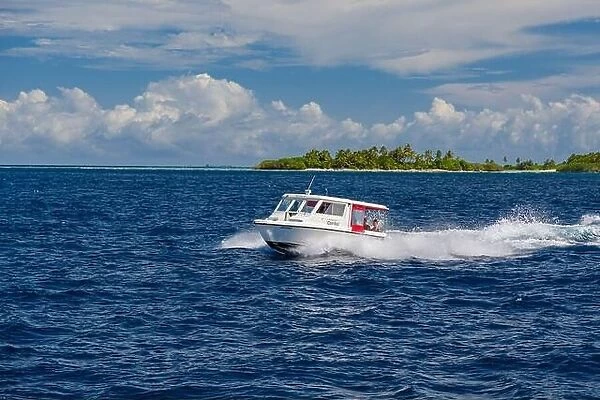 Ari Atoll, Maldives - December 17, 2015: Tourist speedboat fast cruising in the sea at Maldives, Indian Ocean. Speed boat docking to pick up tourists