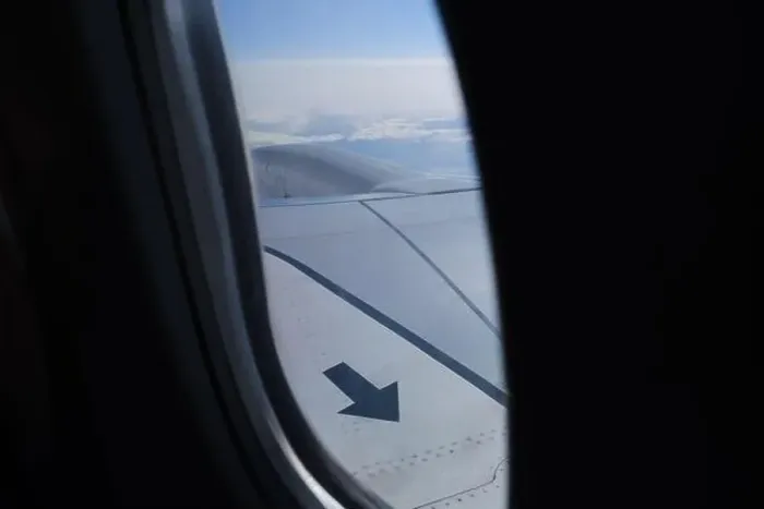 Framed Print : Arrow sign on the airplane wing up in the sky porthole view Framed Print : Arrow sign on the airplane wing up in the sky porthole view
