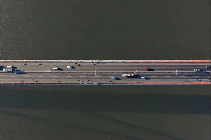 Framed Print : Top ascending aerial view of cable- stayed Can Tho bridge road with driving cars Framed Print : Top ascending aerial view of cable- stayed Can Tho bridge road with driving cars