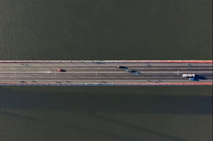 Framed Print : Top ascending aerial view of cable- stayed Can Tho bridge road with driving cars Framed Print : Top ascending aerial view of cable- stayed Can Tho bridge road with driving cars