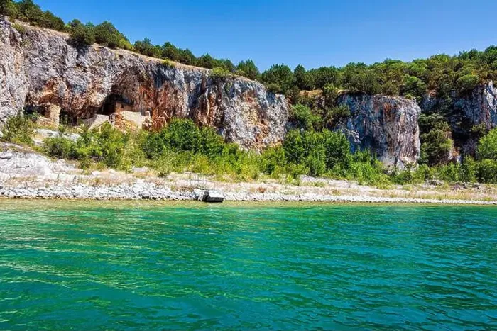 Framed Print : An ascetic building nestled into the rocky cliffs along the shore of Megali Prespa Lake