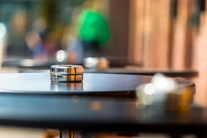Framed Print : An ashtray placed on a round wooden table outdoors, shallow DOF Framed Print : An ashtray placed on a round wooden table outdoors, shallow DOF