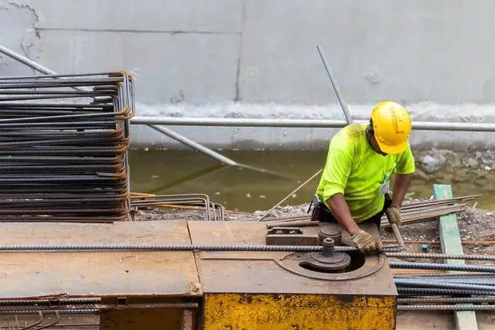 Framed Print : asian construction worker is using steel bending machine bender rebar for casting foundation concrete pillars