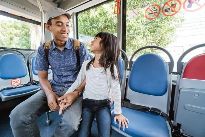 Framed Print : asian father taking his daughter to school by riding bus public transport Framed Print : asian father taking his daughter to school by riding bus public transport