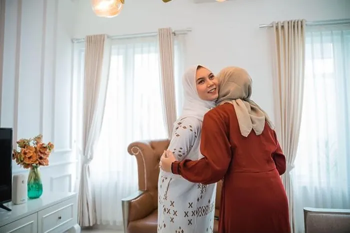Framed Print : Asian Muslim woman in hijab visiting and embracing during Eid Framed Print : Asian Muslim woman in hijab visiting and embracing during Eid
