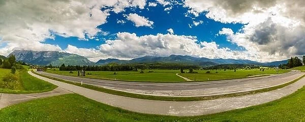Asphalt road panorama in countryside on sunny summer day, wide angle view, Alpine landscape