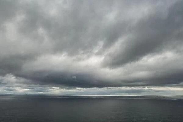 Atlantic ocean water and dramatic cloudy sky background. Sea water texture closeup. Landscape photography