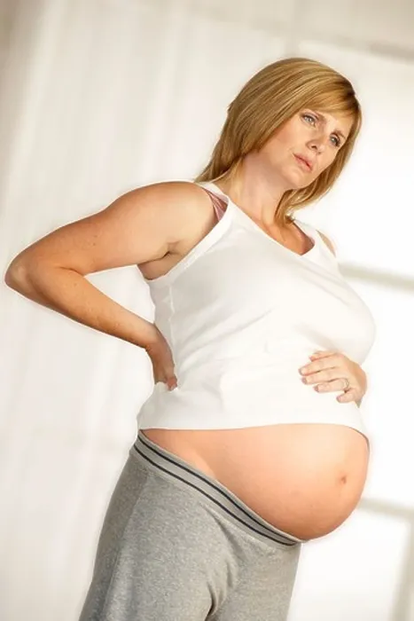 Framed Print : ATTRACTIVE HEALTHY YOUNG PREGNANT WOMAN STANDING IN FRONT OF WINDOW WITH HANDS ON LOWER BACK WITH EXPRESSION OF PAIN Framed Print : ATTRACTIVE HEALTHY YOUNG PREGNANT WOMAN STANDING IN FRONT OF WINDOW WITH HANDS ON LOWER BACK WITH EXPRESSION OF PAIN