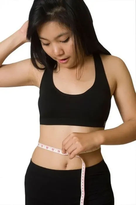 Framed Print : Attractive young Asian girl with measuring tape around her waist Framed Print : Attractive young Asian girl with measuring tape around her waist