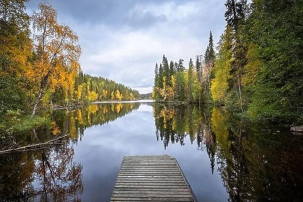 Autumn landscape with idyllic lake and fall colors at daytime in Hossa, National Park, Finland