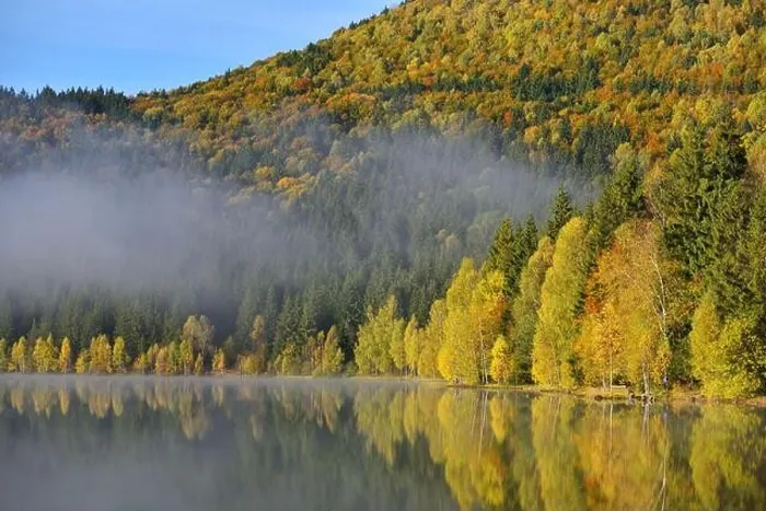 Framed Print : Autumn landscape in the mountains with trees reflecting in the water at St. Ana's lake, Romania Framed Print : Autumn landscape in the mountains with trees reflecting in the water at St. Ana's lake, Romania