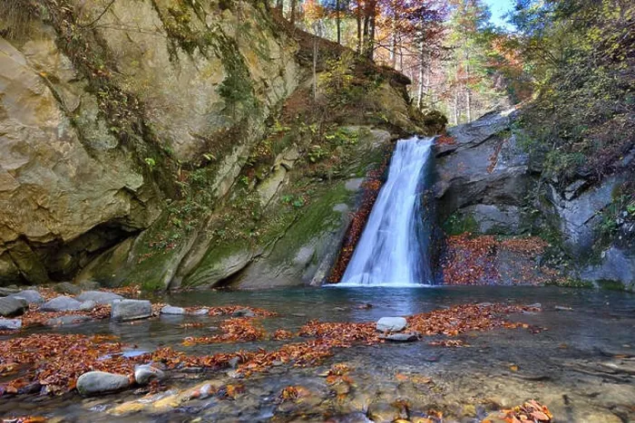 Framed Print : Autumn waterfall and creek woods with yellow trees foliage and rocks in forest mountain