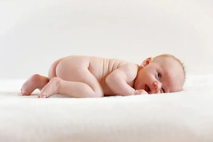 Framed Print : Baby girl, 3 months old, lying on a sheepskin Framed Print : Baby girl, 3 months old, lying on a sheepskin