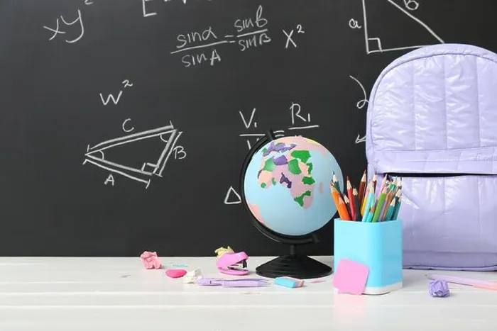 Framed Print : Backpack, stationery and globe on white table against green chalkboard with formulas Framed Print : Backpack, stationery and globe on white table against green chalkboard with formulas
