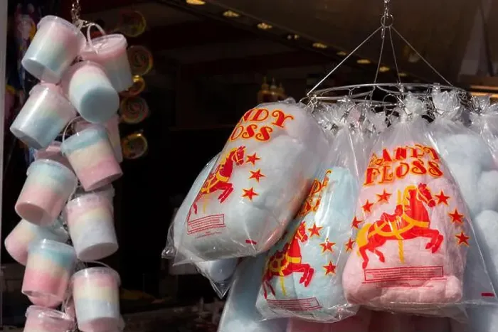 Framed Print : Bag and pots of candy floss hanging for sale at an English fun fair. April 2023 Framed Print : Bag and pots of candy floss hanging for sale at an English fun fair. April 2023