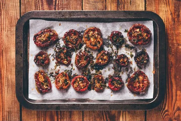 Framed Print : Baking Sheet Full of Freshly Cooked Sun Dried Tomatoes with Thyme and Olive Oil Ready for Preserving. View from Above Framed Print : Baking Sheet Full of Freshly Cooked Sun Dried Tomatoes with Thyme and Olive Oil Ready for Preserving. View from Above