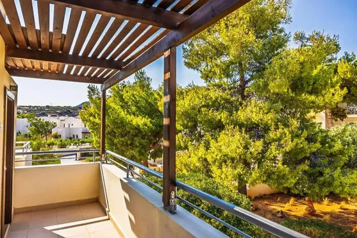 Framed Print : Balcony view with wooden pergola overlooking lush green trees and resort on sunny day on Crete island Framed Print : Balcony view with wooden pergola overlooking lush green trees and resort on sunny day on Crete island