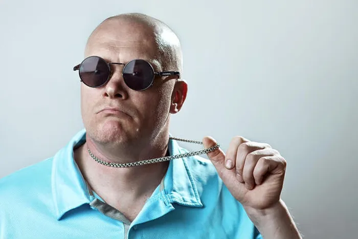 Framed Print : bald brutal man in round glasses and a light t-shirt pulls a silver chain Framed Print : bald brutal man in round glasses and a light t-shirt pulls a silver chain