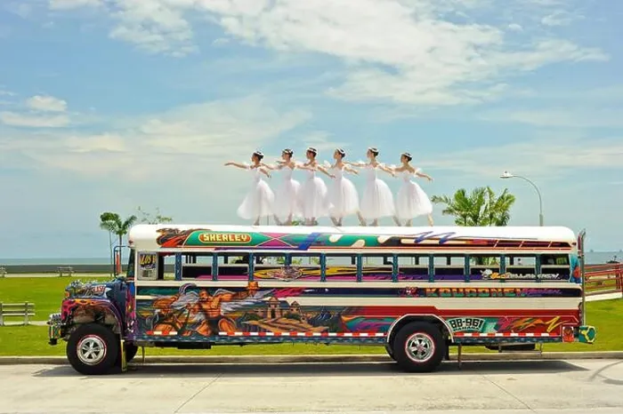 Framed Print : Six ballerinas dance and balance on top of a Diablo Rojo bus on La Cinta Costera, Panama's coastal highway Framed Print : Six ballerinas dance and balance on top of a Diablo Rojo bus on La Cinta Costera, Panama's coastal highway