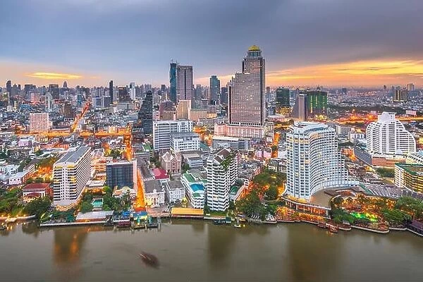 Bangkok, Thailand cityscape on the river at dusk