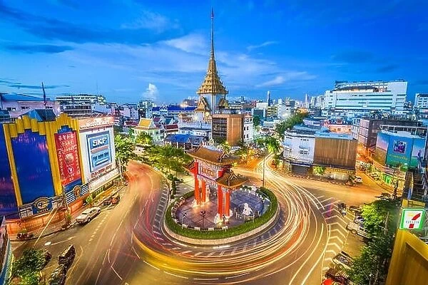 BANGKOK, THAILAND - SEPTEMBER 23, 2015: Traffic passes through Chinatown at Odeon Roundabout. The roundabout marks one end of Chinatown