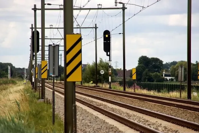 Framed Print : Barriers and red lights at railroad crossing in Moordrecht in the Netherlands