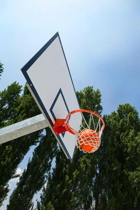 Framed Print : A basketball landing in the net of a backboard