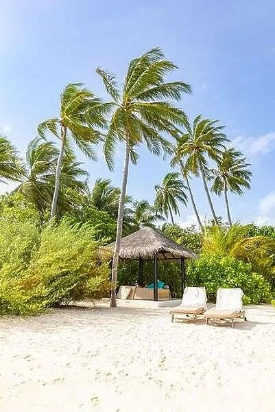 Two beach chairs on idyllic tropical white sand beach. Shadow from the palm trees. Summer landscape, tropical resort hotel beach landscape