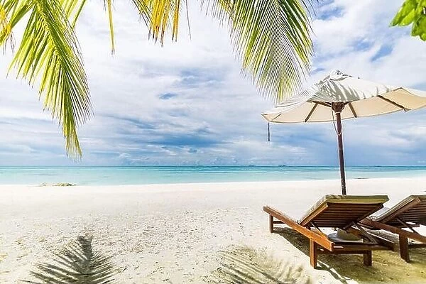 Beach scenery with two chairs and umbrella, couple travel and vacation destination for honeymoon and romantic getaway. Luxury summer island beach