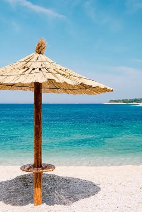 Framed Print : A beach thatched umbrella against the blue sky and azure water on a sandy beach in Croatia, in the city of Primosten Framed Print : A beach thatched umbrella against the blue sky and azure water on a sandy beach in Croatia, in the city of Primosten