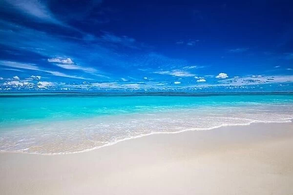 Beach and tropical sea. Stunning summer landscape, shore, coast with calm waves, relaxing seascape horizon over white sand blue sky. Tranquil nature