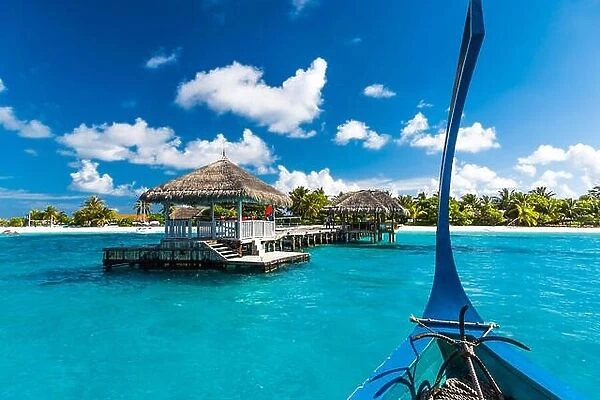 Beautiful beach with water bungalows at Maldives, view from the traditional boat Dhoni