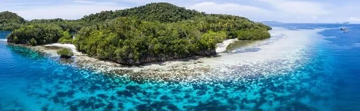 Framed Print : Beautiful coral reefs fringe remote limestone islands in Raja Ampat, Indonesia. The reefs here are home to the world's greatest marine biodiversity