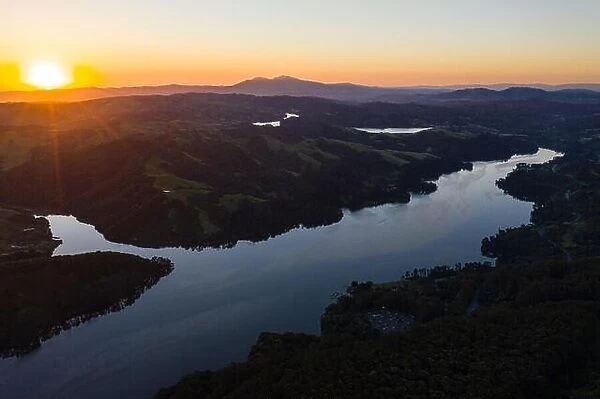A beautiful dawn breaks over the green hills around the San Pablo Reservoir in Northern California. A wet winter has caused lush vegetation growth