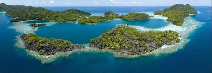 Framed Print : Beautiful and diverse coral reefs surround the dramatic limestone islands that rise from Raja Ampat's varied seascape