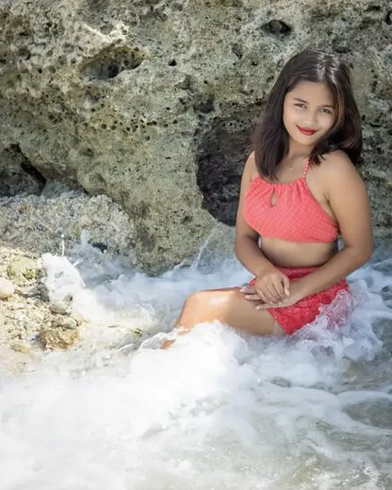 Framed Print : A beautiful Filipina in a red swimsuit smiling and sitting in beach water with a rock in the back Framed Print : A beautiful Filipina in a red swimsuit smiling and sitting in beach water with a rock in the back