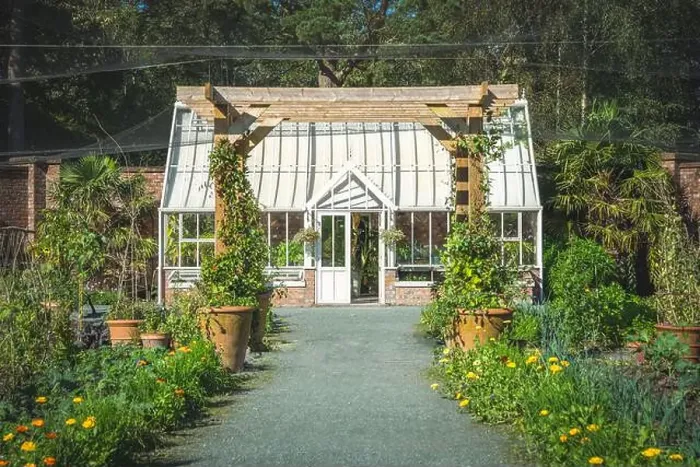 Framed Print : A beautiful formal walled garden with Victorian style greenhouse and vegetable patch in an English country garden Framed Print : A beautiful formal walled garden with Victorian style greenhouse and vegetable patch in an English country garden