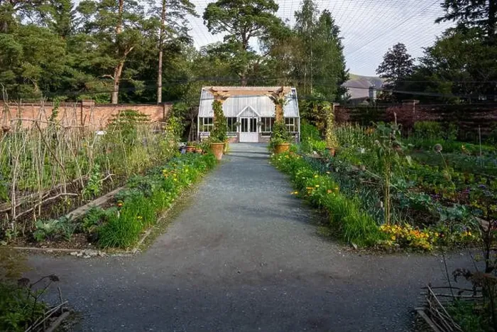 Framed Print : A beautiful formal walled garden with Victorian style greenhouse and vegetable patch in an English country garden Framed Print : A beautiful formal walled garden with Victorian style greenhouse and vegetable patch in an English country garden