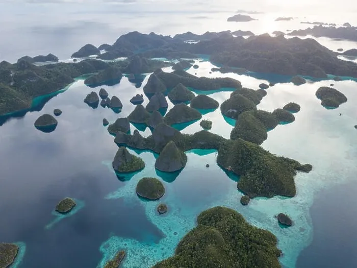 Framed Print : Beautiful limestone islands are fringed by coral reefs in Wayag, Raja Ampat, Indonesia. This region is known for its amazing marine biodiversity Framed Print : Beautiful limestone islands are fringed by coral reefs in Wayag, Raja Ampat, Indonesia. This region is known for its amazing marine biodiversity