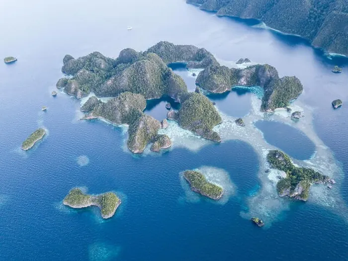 Framed Print : Beautiful limestone islands rise from the calm seas of Raja Ampat, Indonesia. This remote region is known for its extraordinary marine biodiversity Framed Print : Beautiful limestone islands rise from the calm seas of Raja Ampat, Indonesia. This remote region is known for its extraordinary marine biodiversity