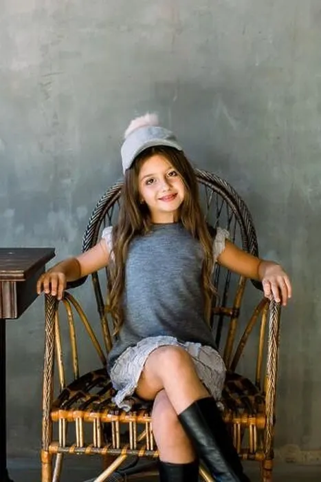 Framed Print : Beautiful little girl with brown long hair and blue eyes sitting in an armchair dressed in gray dress and a hat Framed Print : Beautiful little girl with brown long hair and blue eyes sitting in an armchair dressed in gray dress and a hat
