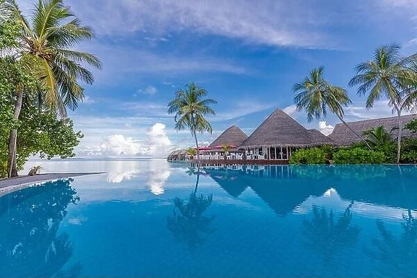 Beautiful luxury hotel pool resort beach, palm trees, loungers with umbrella. Infinity swimming pool, tropical beach landscape, seascape summer travel