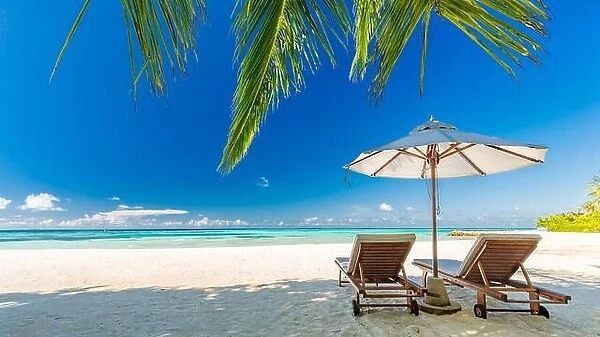 Beautiful Maldives island beach landscape. Luxury resort with chairs and umbrella for summer vacation and holiday background. Exotic tropical beach